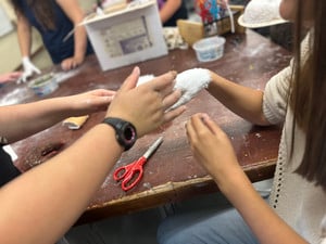 Someone's hand getting plastered