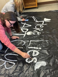 Keegan and Lily painting Art Club sign for haunted trail